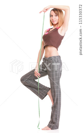 Beautiful young caucasian woman measuring her body with tape isolated 115330372