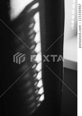 shadow of the rays falling on the wall through curtains. Abstract shadow and striped diagonal light background from window, backdrop and mockup design. black and white shadow of the rays falling on the wall through curtains. Abstract shadow and striped diagonal light background from window, backdrop and mockup design. black and white 115330467
