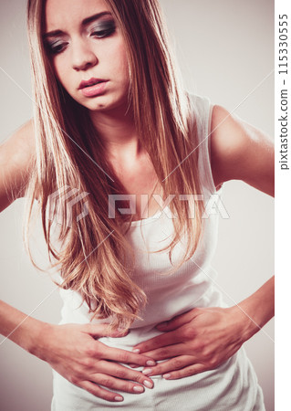 Girl suffering from stomach pain 115330555