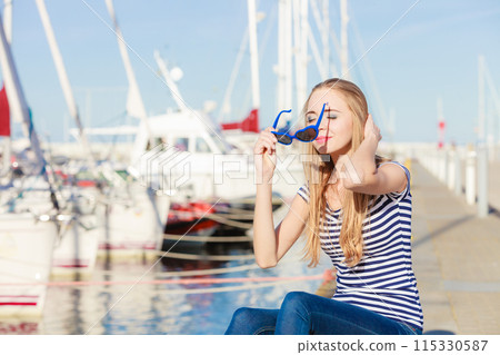 woman in marina against yachts in port 115330587
