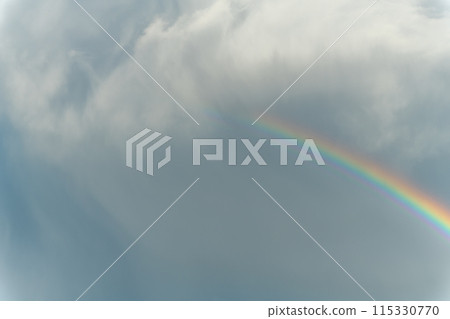 Rainbow appearing in rainy clouds in spring. Rainbow appearing in rainy clouds in spring. 115330770