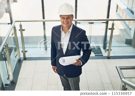 Mature, businessman and architect with blueprint in building for project management, property planning or top view. Contractor, person or engineering portrait with floor plan or happy for renovation Mature, businessman and architect with blueprint in building for project management, property planning or top view. Contractor, person or engineering portrait with floor plan or happy for renovation 115330957