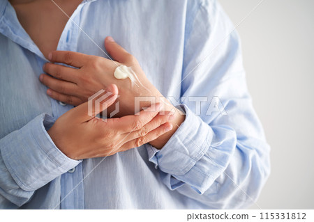 Hands in a blue shirt smear cream. Hands in a blue shirt smear cream. 115331812