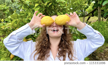 tropical country lemons grow on a tree blonde girl plays with lemons fooling around in the frame tropical country lemons grow on a tree blonde girl plays with lemons fooling around in the frame 115331896