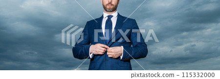 Professional man crop view. Unshaven man buttoning suit. Man sky background 115332000