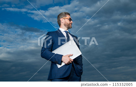 handsome freelancer man with laptop outdoor. freelancer man with laptop wearing suit. handsome freelancer man with laptop outdoor. freelancer man with laptop wearing suit. 115332005