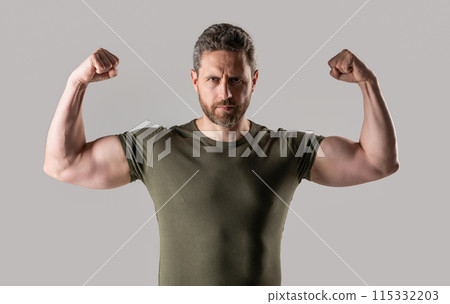 muscular strong man in studio. photo of strong muscular man with stubble. strong muscular man muscular strong man in studio. photo of strong muscular man with stubble. strong muscular man 115332203