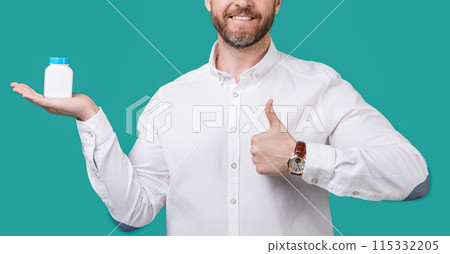 cropped photo of man holding medication, healthcare. man with medication isolated on blue cropped photo of man holding medication, healthcare. man with medication isolated on blue 115332205
