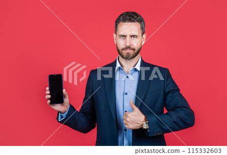 mature bearded businessman in suit presenting product. confident guy hold smartphone. 115332603