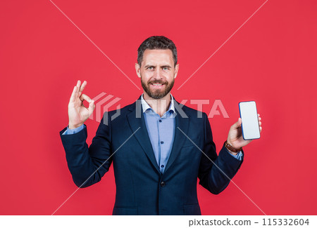 successful male ceo. confidence and success. office worker use phone. ok gesture. 115332604