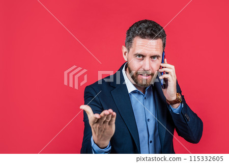 handsome man in formalwear speaking on smartphone, conversation 115332605