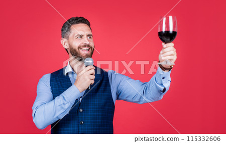 Happy man toastmaster raise glass of wine to propose toast before drinking red background, cheers 115332606