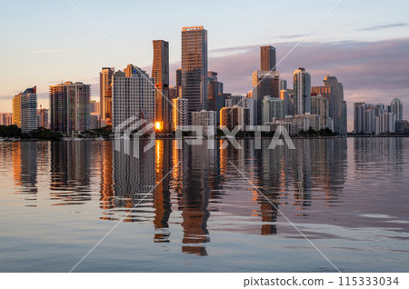 City of Miami, Florida skyline at sunset reflected in calm Biscayne Bay. 115333034