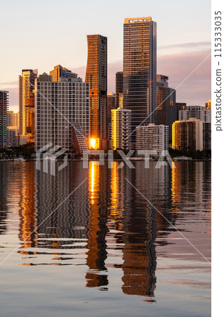 City of Miami, Florida skyline at sunset reflected in calm Biscayne Bay. 115333035