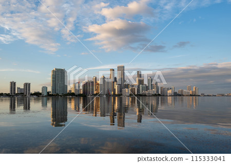 City of Miami, Florida skyline at sunset reflected in calm Biscayne Bay. 115333041