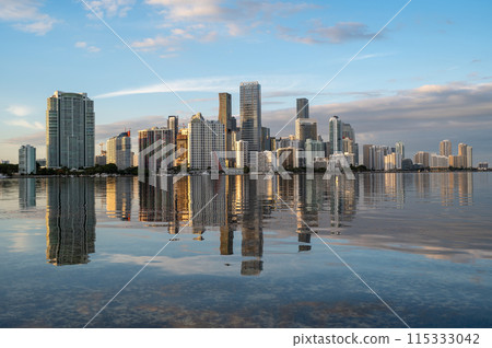 City of Miami, Florida skyline at sunset reflected in calm Biscayne Bay. 115333042