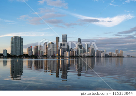 City of Miami, Florida skyline at sunset reflected in calm Biscayne Bay. City of Miami, Florida skyline at sunset reflected in calm Biscayne Bay. 115333044