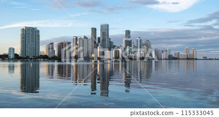 City of Miami, Florida skyline at sunset reflected in calm Biscayne Bay. City of Miami, Florida skyline at sunset reflected in calm Biscayne Bay. 115333045