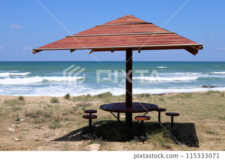 Sun canopy in a city park on the seashore. 115333071