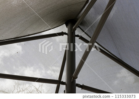 Sun canopy in a city park on the seashore. Sun canopy in a city park on the seashore. 115333073