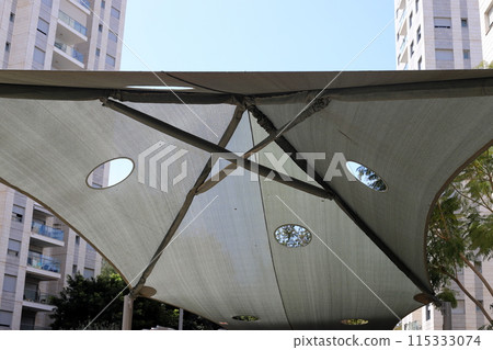Sun canopy in a city park on the seashore. 115333074
