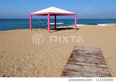 Sun canopy in a city park on the seashore. 115333086