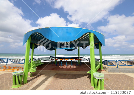 Sun canopy in a city park on the seashore. Sun canopy in a city park on the seashore. 115333087