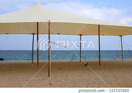 Sun canopy in a city park on the seashore. Sun canopy in a city park on the seashore. 115333089