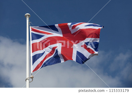 The flag of the United Kingdom waving in mid air The flag of the United Kingdom waving in mid air 115333179