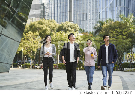 group of young asian people talking chatting while walking on street 115333237