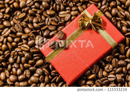 Red gift box on roasted coffee beans. 115333239