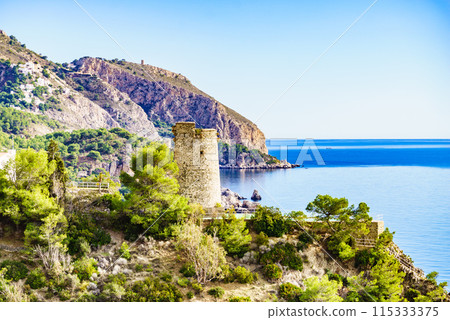 Spanish sea coast with tower, Andalusia 115333375