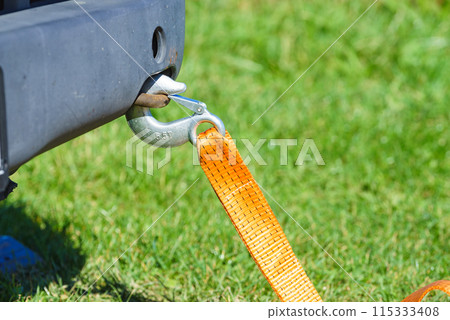 Tow hook with orange strap on car. Towing equipment. Tow hook with orange strap on car. Towing equipment. 115333408