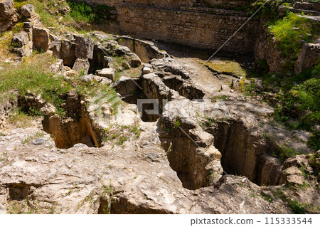 Remains of weathered stone tombs of Punic necropolis in Carthage 115333544