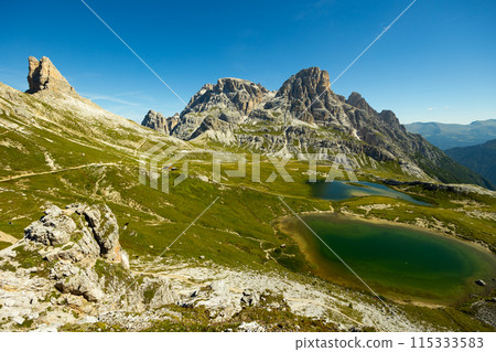View of rocky summits of Sexten Dolomites and mountain lakes Laghi dei Piani 115333583