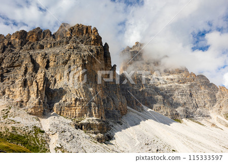 Paternkofel mountain in Italian Dolomites against blue sky with rare clouds. Paternkofel mountain in Italian Dolomites against blue sky with rare clouds. 115333597