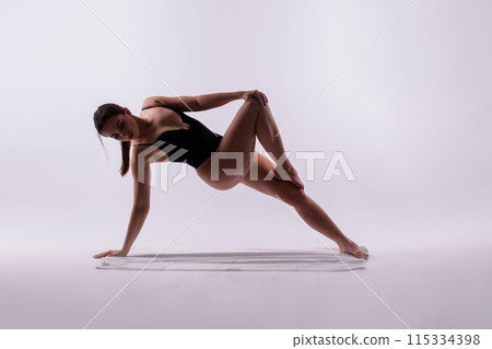 Beautiful woman doing poses on yoga class. Studio shot. Beautiful woman doing poses on yoga class. Studio shot. 115334398