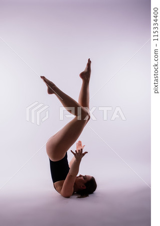 Beautiful woman doing poses on yoga class. Studio shot. 115334400
