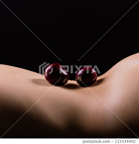 Close up of woman back with laying onion, low key 115334402