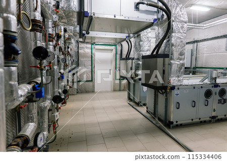 Interior industrial gas boiler with a lot of piping, pumps and valves Interior industrial gas boiler with a lot of piping, pumps and valves 115334406