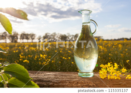 Glass Jug of Water in Flower Field Glass Jug of Water in Flower Field 115335137