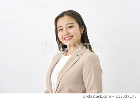 Smiling young business woman, white background, looking at camera 115337175