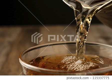 Pour barley tea into a cup 115337775