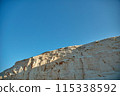 Breathtaking White Cliff Against Clear Blue Sky 115338592