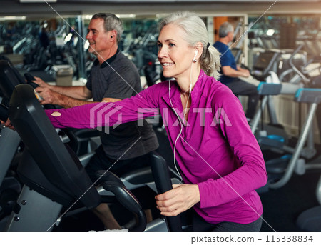 Woman, earphones and exercise machine for training, sports and music for performance or action. Female person, stationary and equipment at gym for fitness, sound and streaming radio for cardio bike Woman, earphones and exercise machine for training, sports and music for performance or action. Female person, stationary and equipment at gym for fitness, sound and streaming radio for cardio bike 115338834