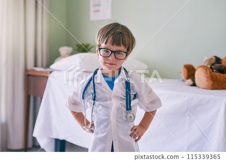 Boy, child and doctor with happy portrait for young physician, confident and future career in medicine or healthcare. Kid, glasses and educational roll play for growth or development and medical. 115339365
