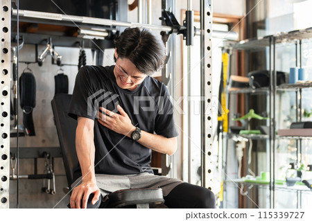 Young athlete Asian man with accumulated fatigue at the gym 115339727