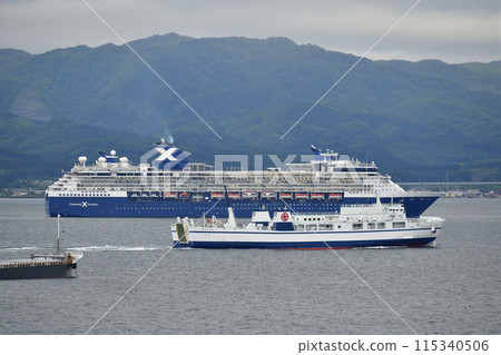 Photographing the cruise ship Celebrity Millennium sailing through Hakodate Bay in Hakodate, Hokkaido in early summer 115340506