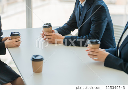 Businessmen and women taking a break in the office cafe space Businessmen and women taking a break in the office cafe space 115340543