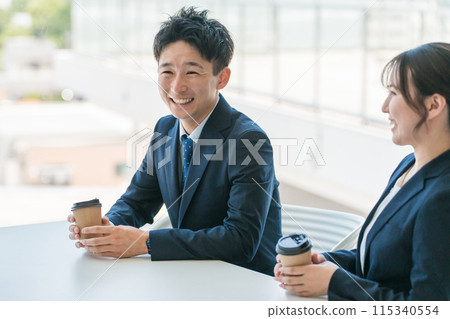 Businessmen and women chatting in the office break area 115340554